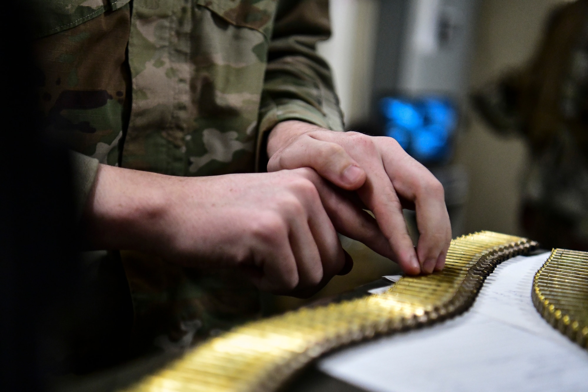 An Airman counts bullets.