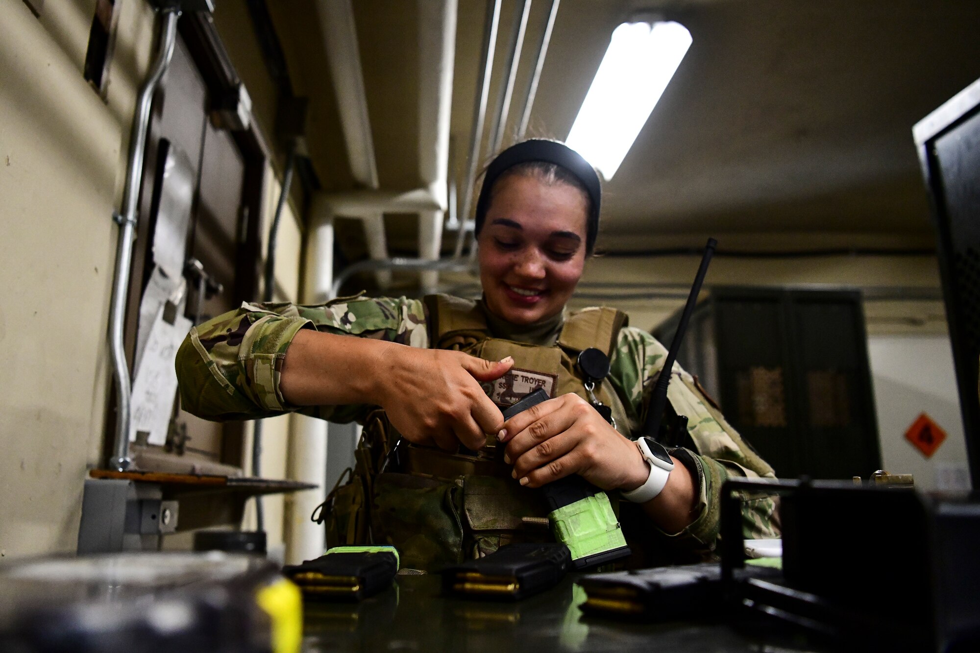 An Airman places bullets into a magazine.