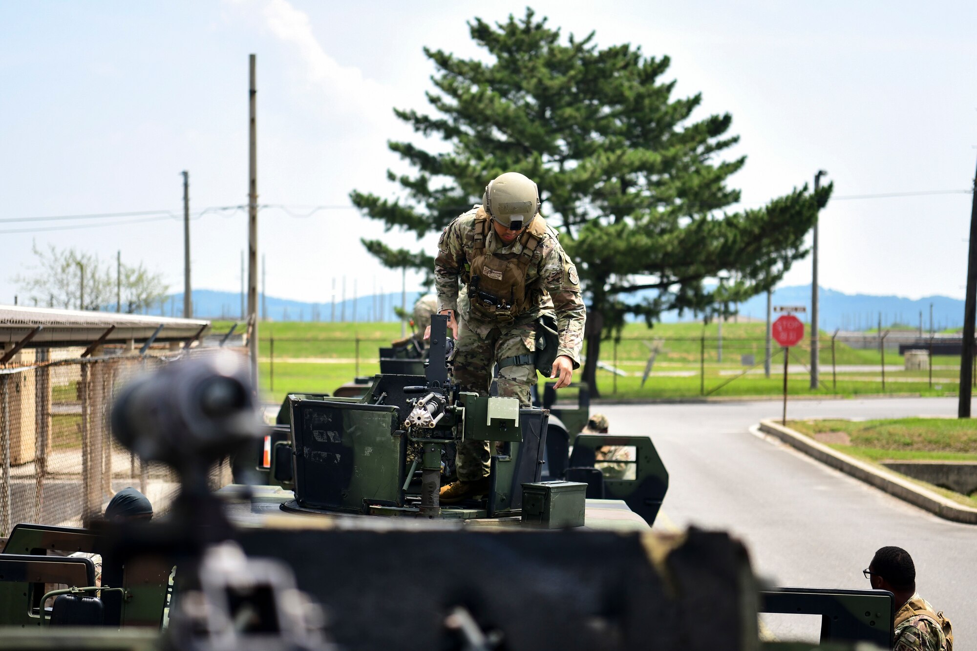 An Airman places bullets into a machine gun.