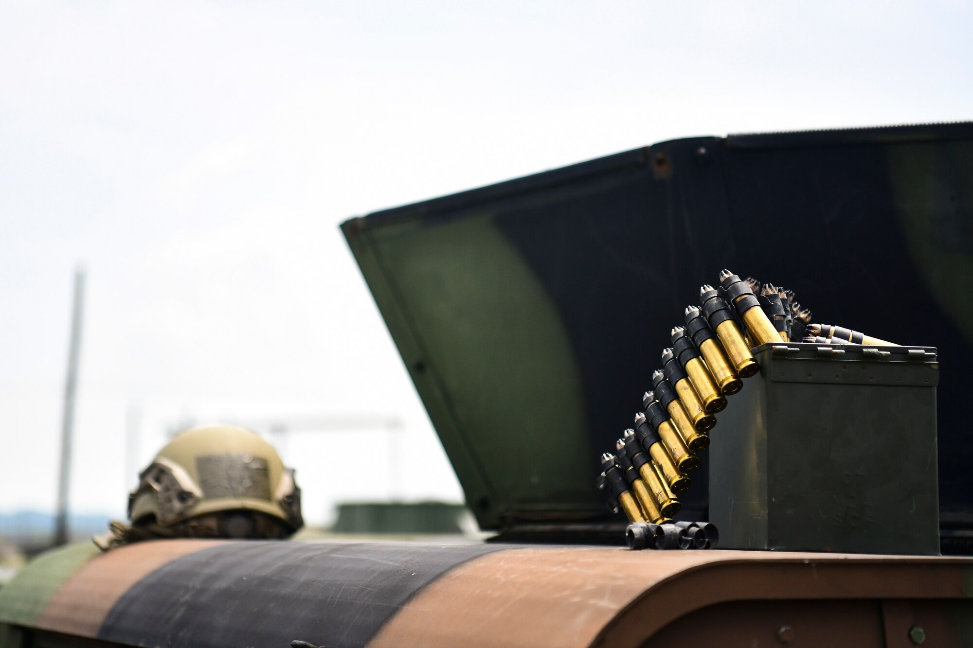 An Airman's helmet and bullets rest on a Humvee.