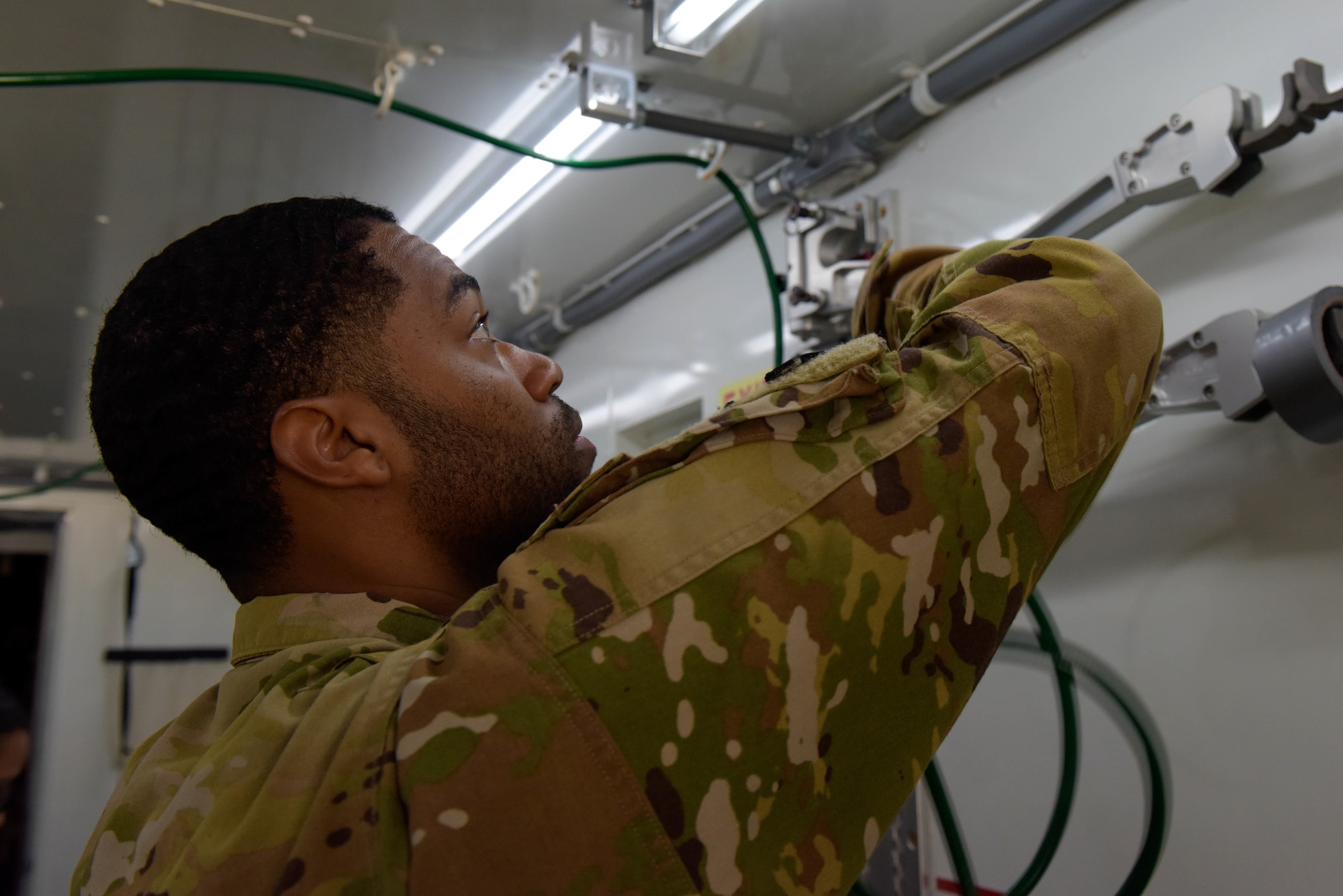 U.S. Air Force Staff Sgt. Frederick Broussard sets up oxygen lines in a Negatively Pressurized Conex Lite