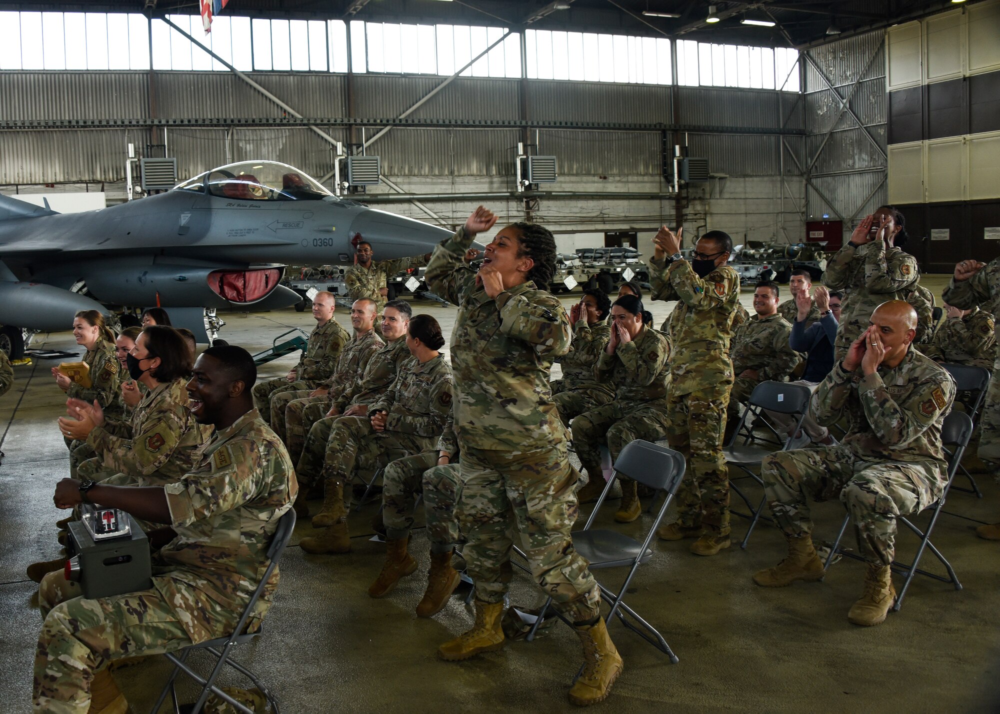 Members of the 52nd Medical Group cheer for an award winner from their group during the 52nd Fighter Wing’s Second Quarter Awards ceremony on Spangdahlem Air Base, Germany, July 30, 2021.