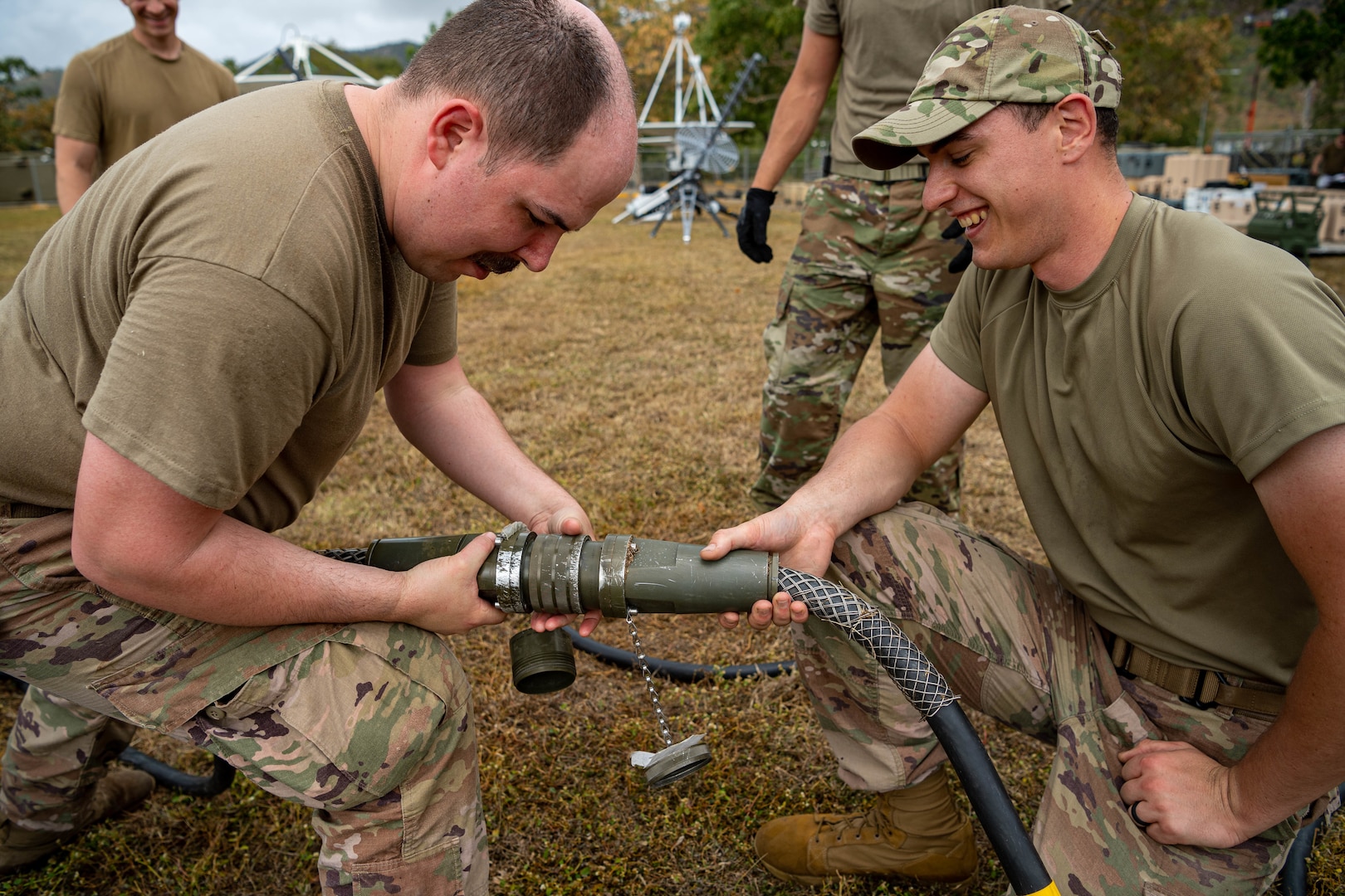 American service members inspect equipment power lines.