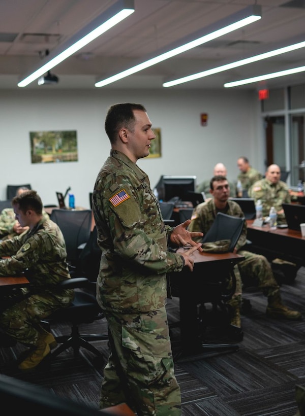 Sgt. Tucker Huff is on his computer during cyber shield 20 and is being photographed in preparation for training week. Various soldiers for KYARNG prepping for training week.