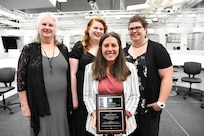 IMAGE: Sarah Moore, engineer in the Human Systems Integration (HSI) division and awardee of the 2021 G. Dennis White Early Career HSI Practitioner award, poses with the White family.