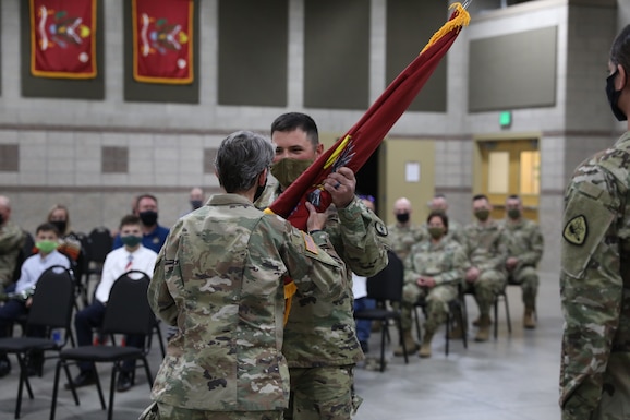 Maj. Barbara Blanke passes the guidon to 1st Sgt. Donnelly, the incoming first sergeant of HHD 640th Regiment, RTI, at Camp Williams, Utah, April 17, 2021