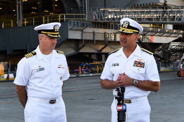 SAN DIEGO (August 2, 2021) Capt. P. Scott Miller, left, commanding officer of Nimitz-class aircraft carrier USS Carl Vinson (CVN 70), and Rear Adm. Daniel Martin, right, commander, Carrier Strike Group (CSG) 1, speak with local media.