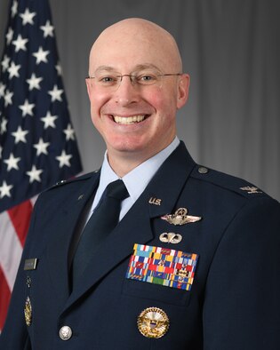 Photo of Airman with U.S. flag in the background