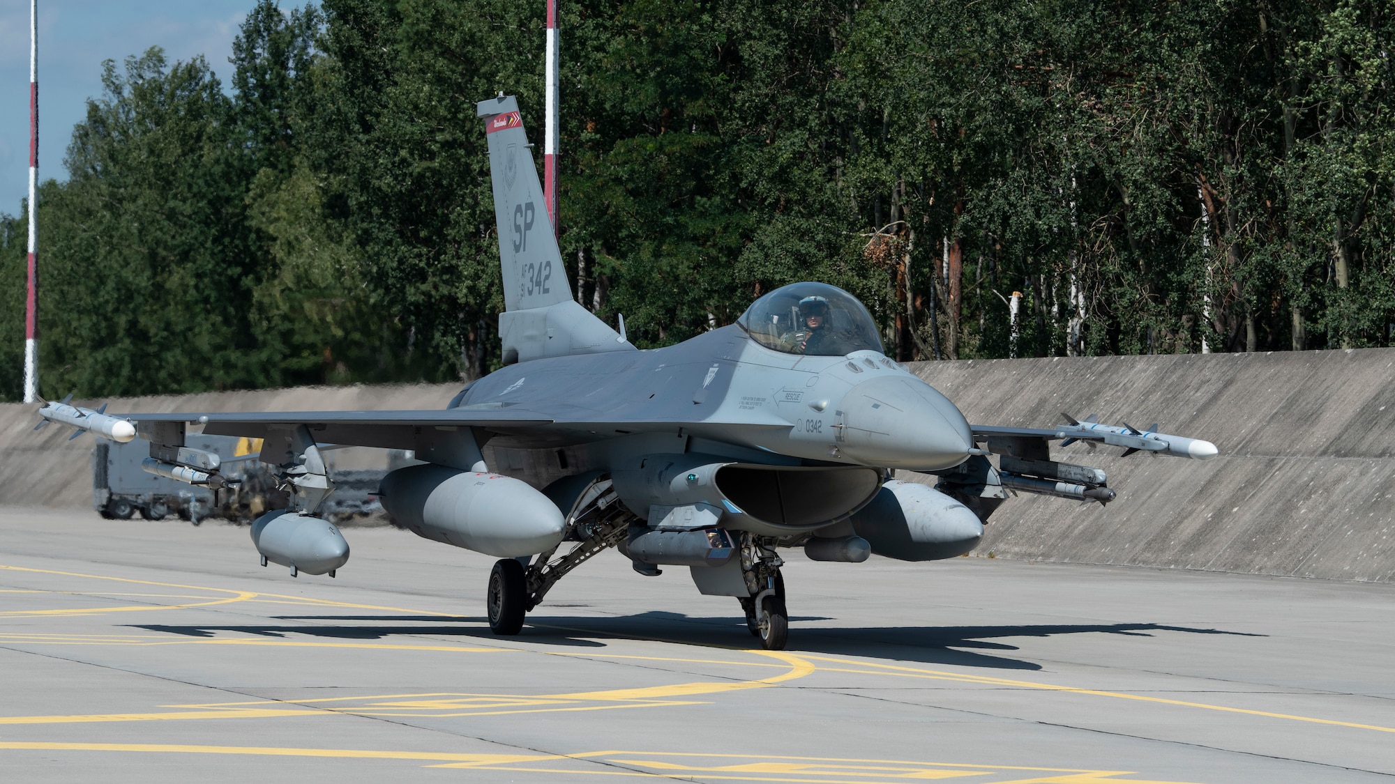 A U.S. Air Force F-16 Fighting Falcon taxis on the flightline upon arrival at Łask Air Base, Poland, July 30, 2021. A contingent of F-16s and support personnel assigned to the 480th Expeditionary Fighter Squadron are in Poland to participate in Aviation Detachment Rotation 21.3. (U.S. Air Force photo by Tech. Sgt. Anthony Plyler)