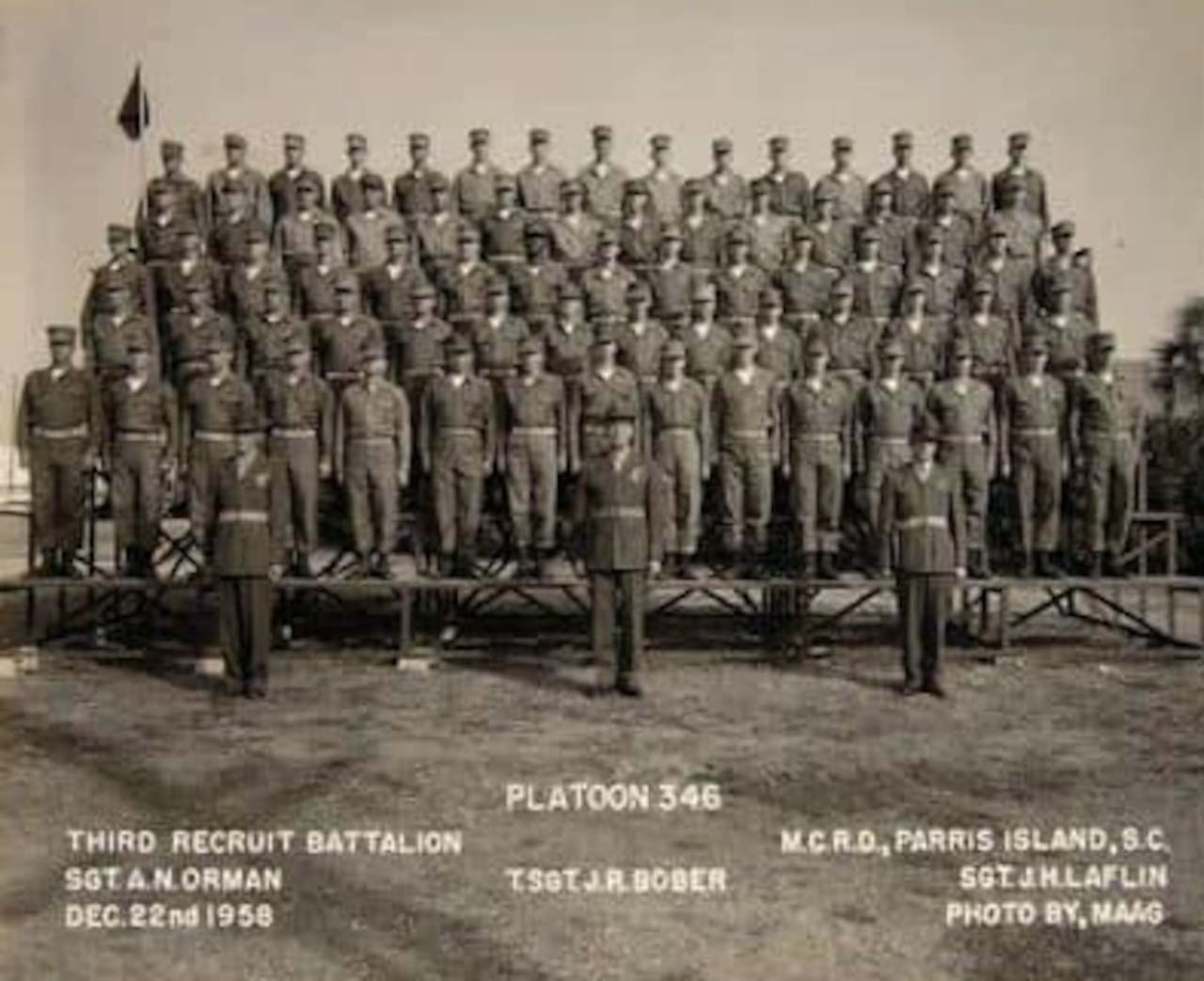 A group of Marines pose for an official photo.