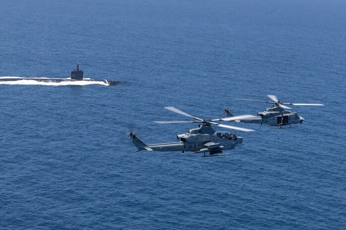 U.S. Marine Corps AH-1Z Viper and UH-1Y Venom with Marine Light Attack Helicopter Squadron 267, Marine Aircraft Group 16, 3rd Marine Aircraft Wing, fly over a U.S. Navy Submarine during Advanced Naval Basing evolution of Summer Fury 21 at San Clemente, California, July 20, 2021. Advanced Naval Basing offering forward logistics and support, as well as sensor and strike capabilities that make a significant contribution to undersea warfare campaigns in the Indo-Pacific region. Summer Fury is an exercise conducted by 3rd MAW in order to maintain and build capability, strength and trust within its units to generate the readiness and lethality needed to deter and defeat adversaries during combat operations as the U.S. Marine Corps refines tactics and equipment in accordance with Force Design 2030.