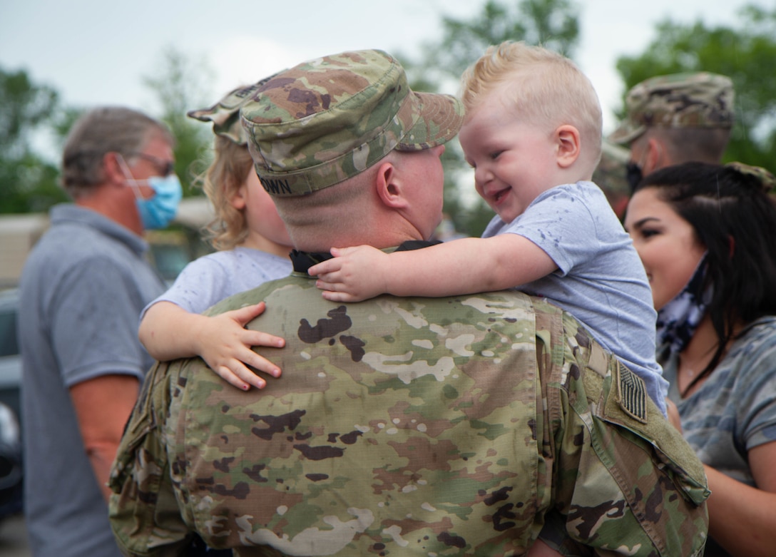 Family Members await the arrival of their Soldier from the 223rd Military Police Company after their deployment. The Soldiers arrived to Buechel National Guard Armory Aug 22 after recently returning from their overseas deployment