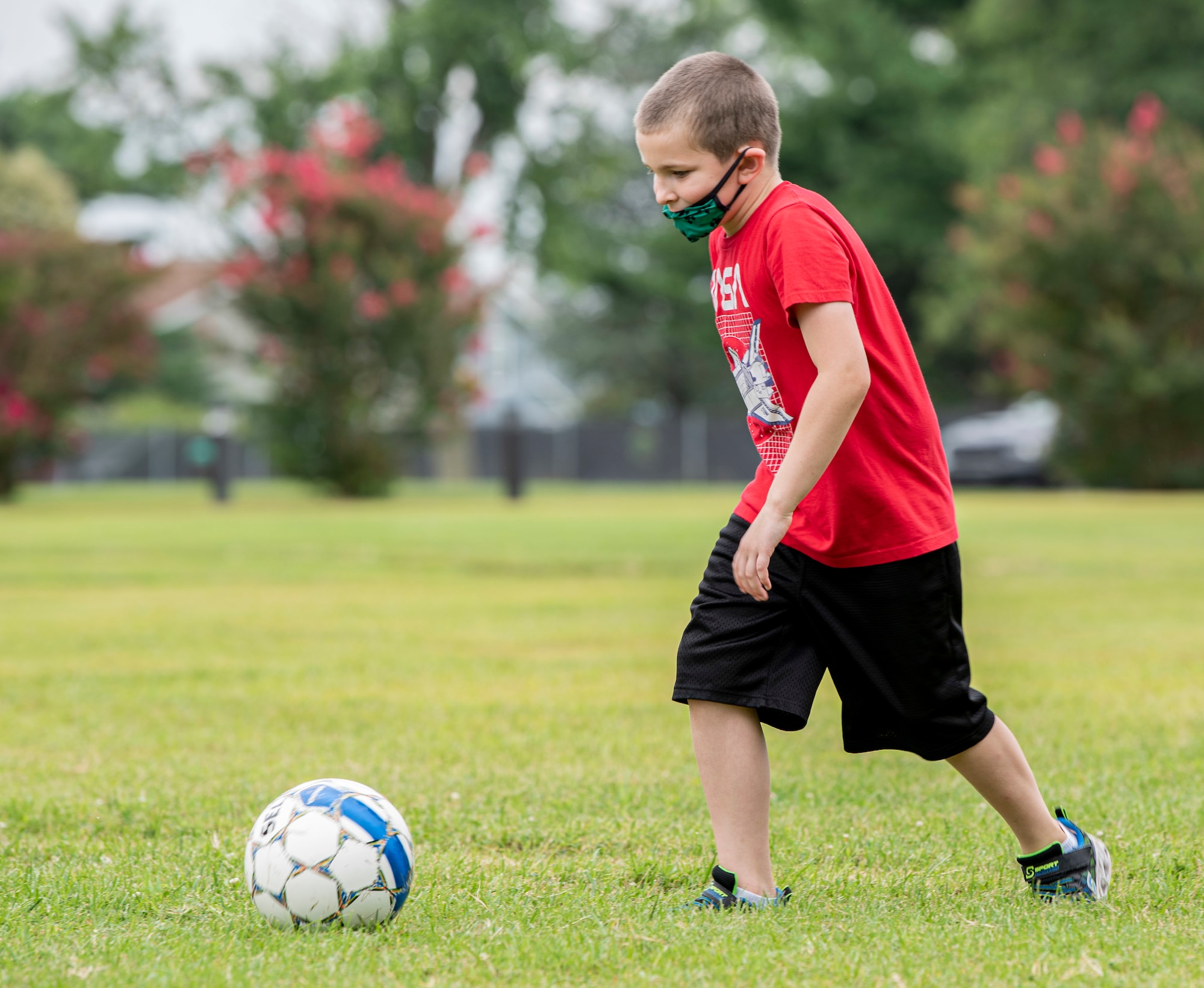 A member of Team Dover kicks a soccer ball during the youth soccer camp at the Youth Center on Dover Air Force Base, Delaware, August 3, 2021. During the camp, participants learned basic soccer skills that they put to use in team scrimmages. (U.S. Air Force photo by Tech. Sgt. Nicole Leidholm)