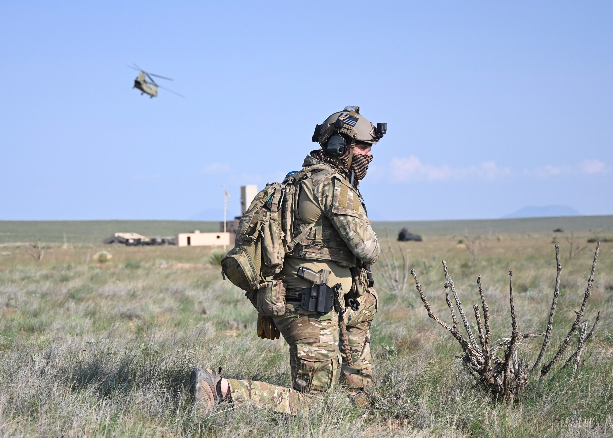 An Exercise Zia Sun participant awaits instructions after exiting a CH-47 Chinook, July 20, 2021, on White Sands Missile Range, New Mexico. The scenario required participants to engage in close combat against opposing forces acted out by Zia Sun Cadre. (U.S. Air Force photo by Airman 1st Class Adrian Salazar)