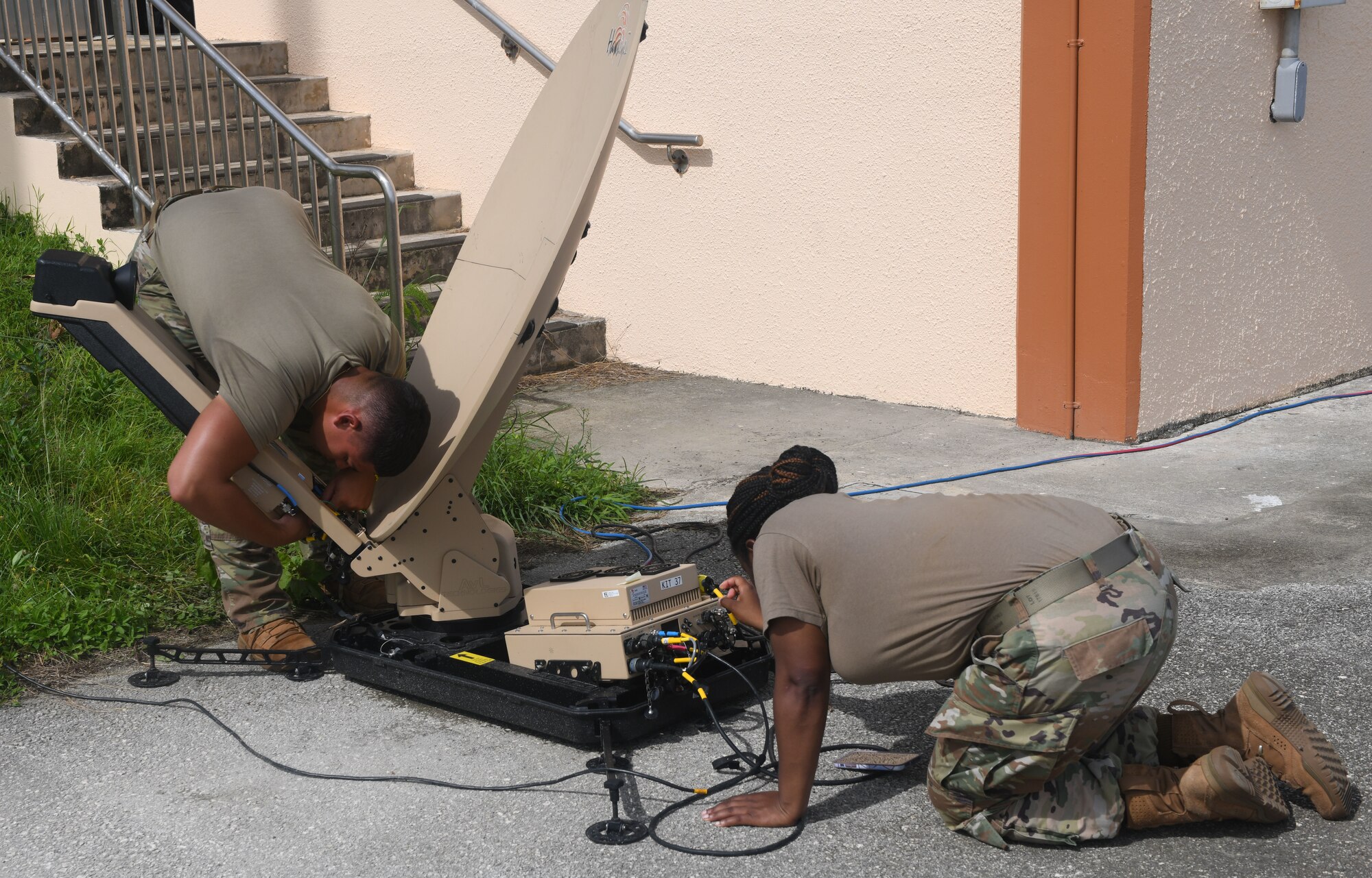 U.S. Air Force Airmen 1st Class Brayan Rivera, 644th Combat Communications Squadron, deployed from Andersen Air Force Base, Guam, radio frequency transmissions systems administrator, and Tech. Sgt. Iesha Richardson, 673rd Communications Squadron, deployed from Joint Base Elmendorf-Richardson, Alaska, bravo team leader for cyber control operators, set up a satellite at the Tinian International Airport, Tinian, during Pacific Iron 2021, July 26, 2021. Pacific Iron 2021 is a Pacific Air Forces dynamic force employment operation to project forces into USINDOPACOM’s area of responsibility in support of the 2018 National Defense Strategy which called on the military to be a more lethal, adaptive, and resilient force. (U.S. Air Force photo by Tech. Sgt. Benjamin Sutton)