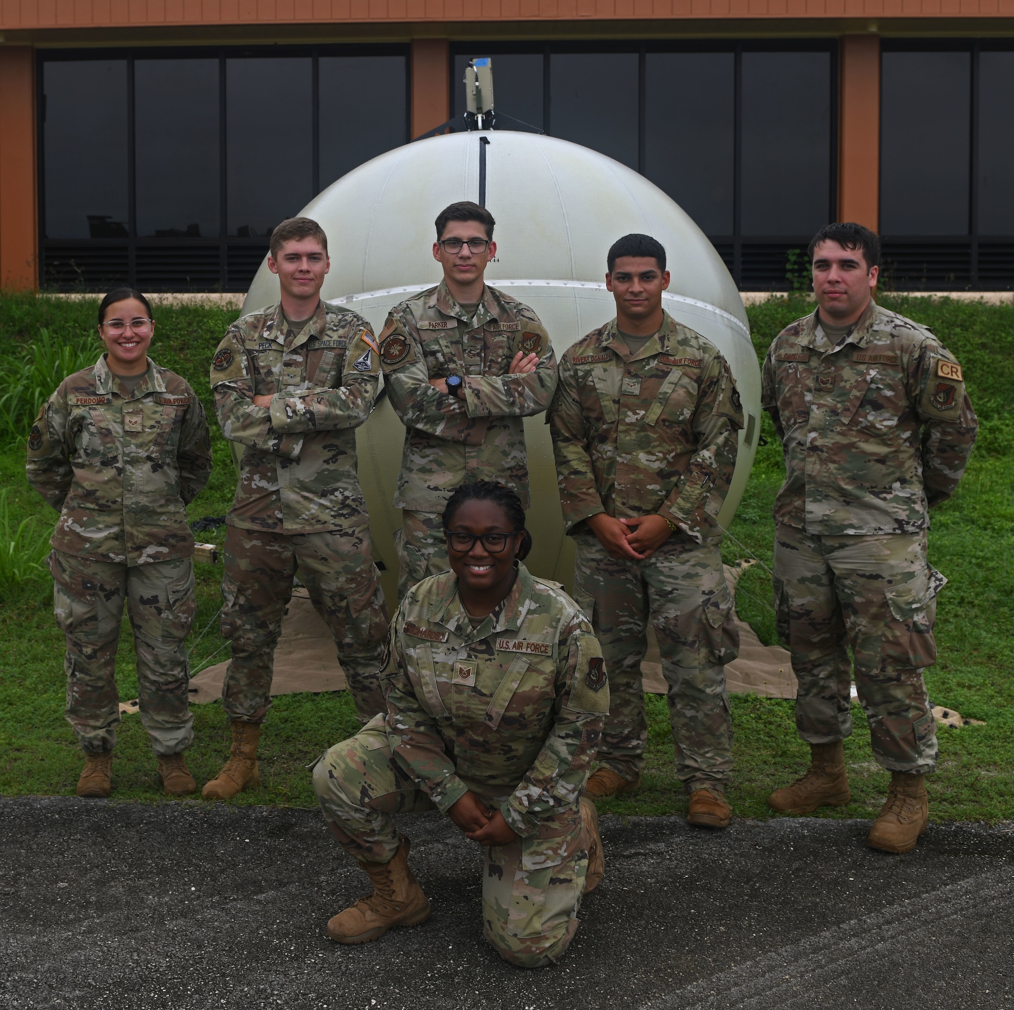 A joint team of U.S. Air Force Airmen and a U.S. Space Force Guardian from the 673rd Communications Squadron, Joint Base Elmendorf-Richardson, Alaska, and the 644th Combat Communications Squadron, Andersen Air Force Base, Guam, pose for a photo at the Tinian International Airport, Tinian, during Pacific Iron 2021, Aug. 2, 2021. Pacific Iron 2021 is a Pacific Air Forces dynamic force employment operation to project forces into USINDOPACOM’s area of responsibility in support of the 2018 National Defense Strategy which called on the military to be a more lethal, adaptive, and resilient force. (U.S. Air Force photo by Tech. Sgt. Benjamin Sutton)