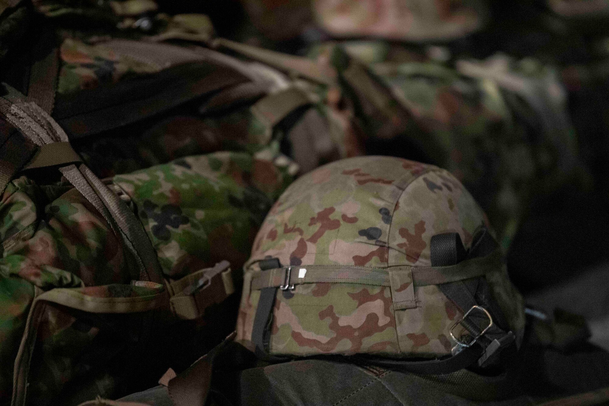 A Japan Ground Self-Defense Force soldier with the 1st Airborne Brigade helmet sits on his gear during Exercise Forager 21 at Yokota Air Base, Japan, July 29, 2021.