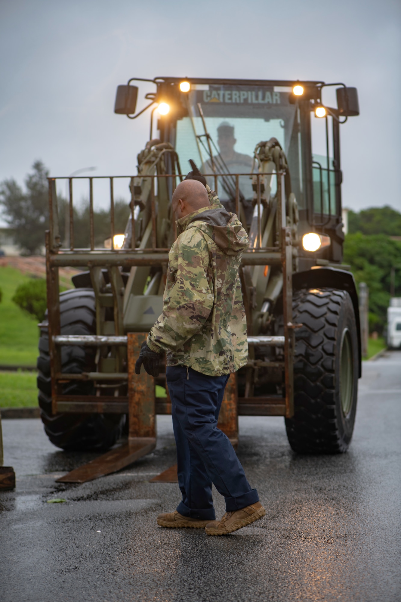 U.S. Air Force Tech. Sgt. Jerome Fontenot directs a forklift to pick up cinder blocks used for securing tents