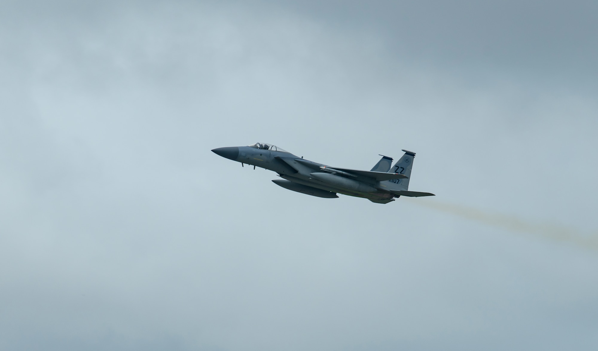 A F-15C flies over Kadena Air Base