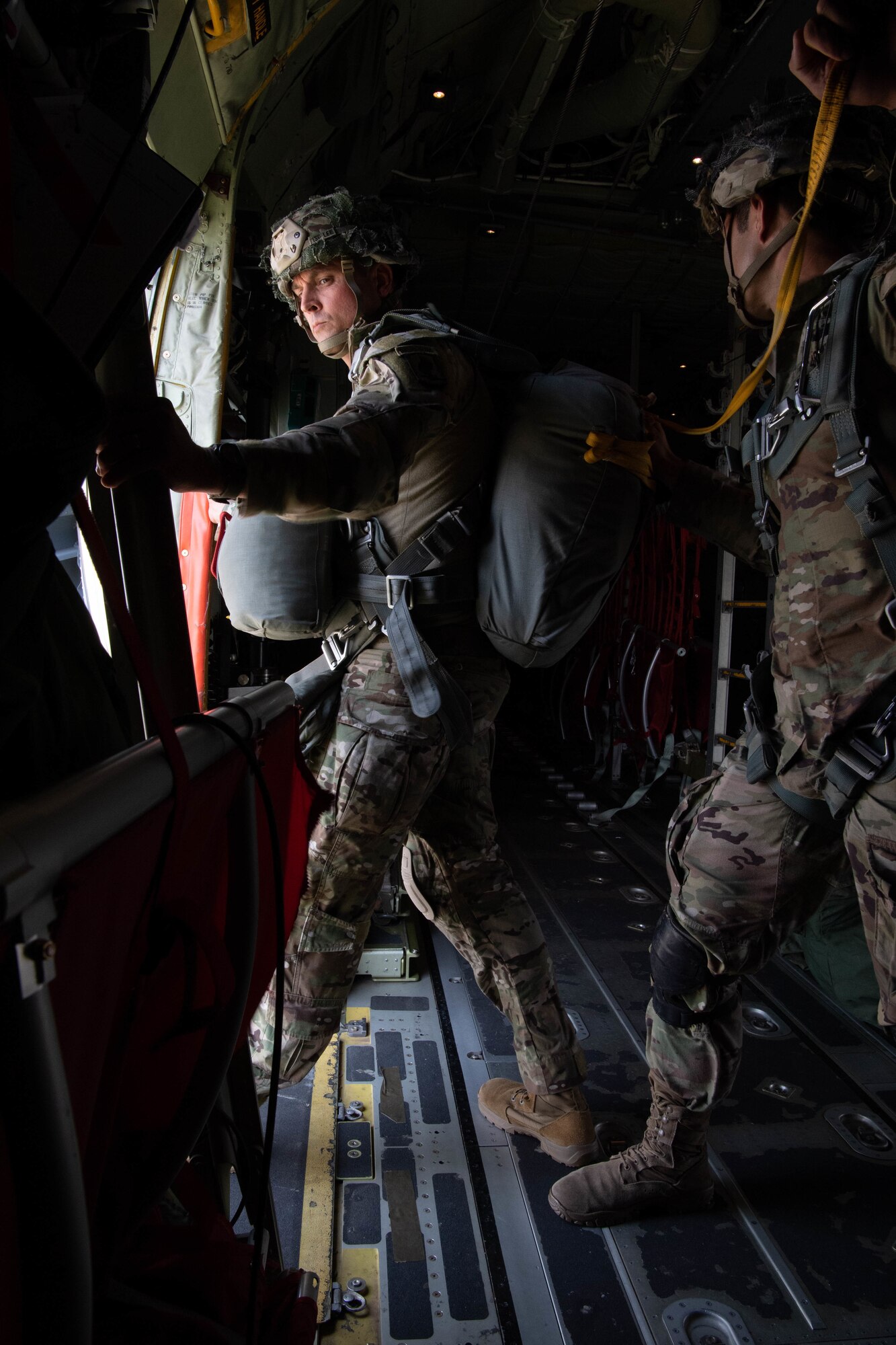 Soldier standing at open aircraft door.