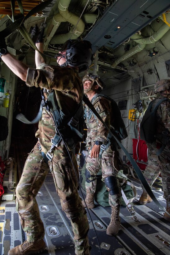 An Airman closing aircraft door