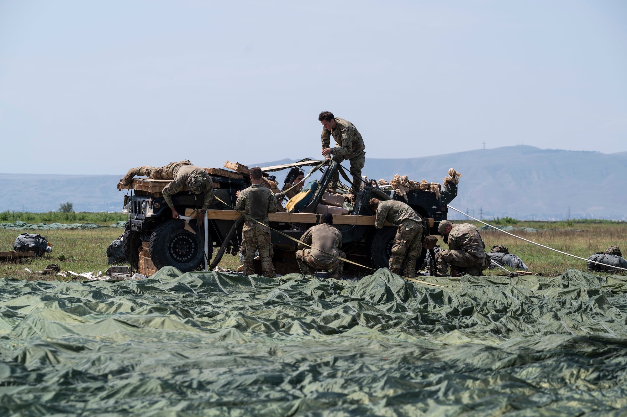 U.S. Army soldiers assigned to the 1st Squadron, 91st Cavalry Regiment, 173rd Infantry Brigade Combat Team (airborne) retrieve a piece of heavy cargo after an airdrop demonstration during exercise Agile Spirit 21