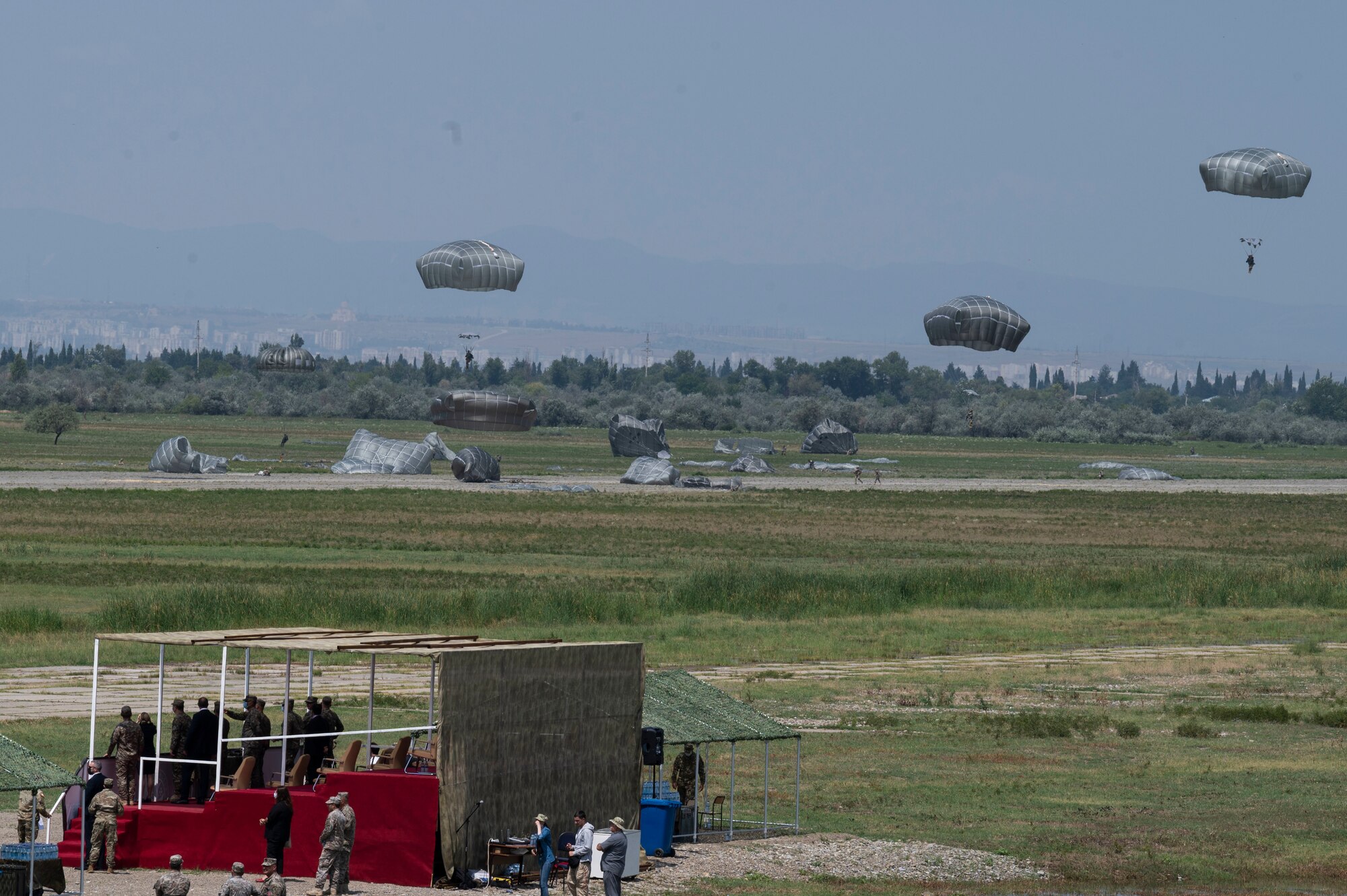 U.S. Army soldiers assigned to the 1st Squadron, 91st Cavalry Regiment, 173rd infantry brigade combat team (airborne)  and Georgian military personnel land at a dropzone after static-line jumping from a U.S. Air Force C-130J Super Hercules aircraft during exercise Agile Spirit 21