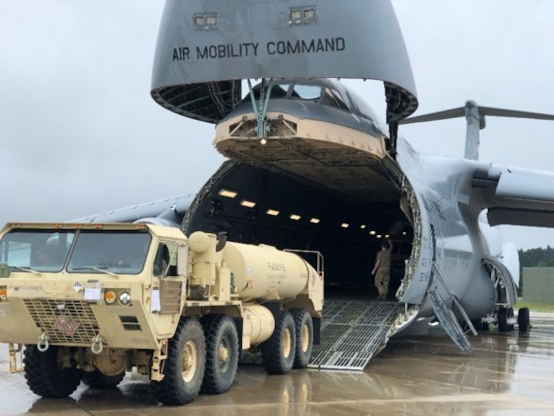 The 641st Regional Support Group from St. Petersburg, FL in coordination with the Arrival/Departure Airfield Control Group download a HEMTT Tanker from a C-5 Galaxy during Pershing Strike 21 at Fort McCoy, Wis.
