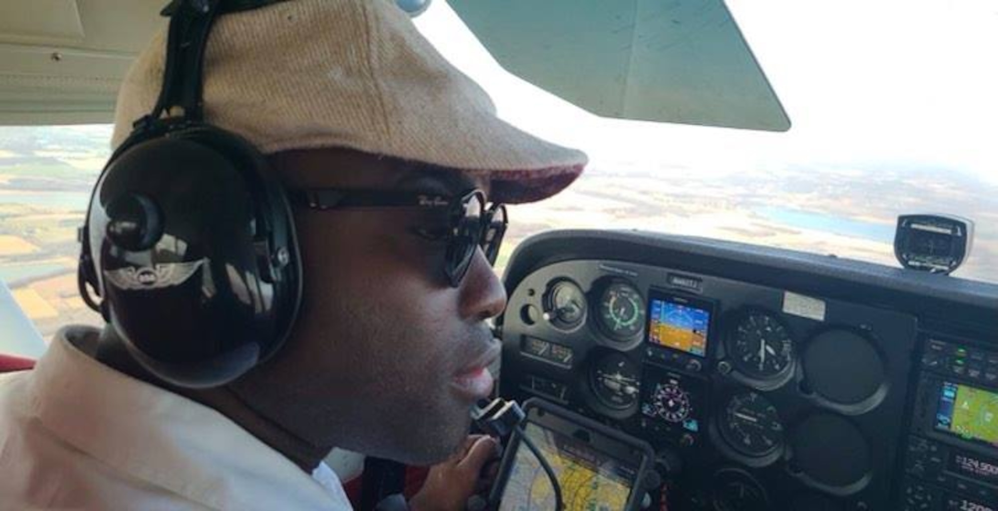 Senior Airman Ajay Vogar, 379th Expeditionary Maintenance Squadron commander support staff security manager, receives instructions while participating in an inflight pilot training course over Eden Prairie, Minnesota.