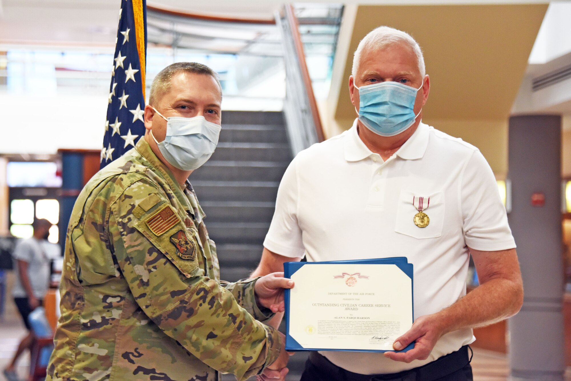 87th Medical Group commander honors award to 87th MDG pharmacist.