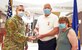 87th Medical Group commander honors award to 87th MDG pharmacist.
