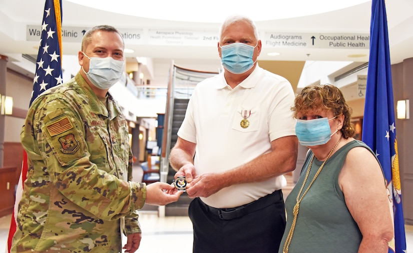 87th Medical Group commander honors award to 87th MDG pharmacist.