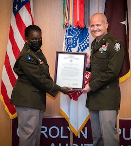 Army Maj. Gen. Telita Crosland, deputy surgeon general, presents Brig. Gen. Clinton Murray, Brooke Army Medical Center commanding general, with a certificate of promotion