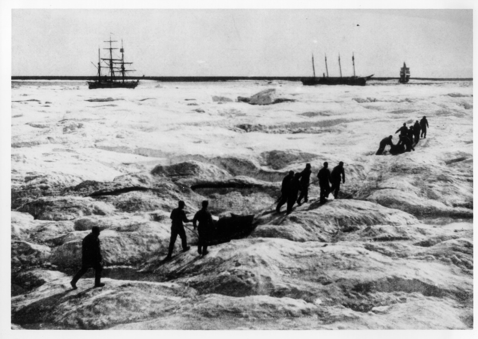 Personnel of the RCS Overland Expedition approach the stranded whaling fleet in 1898.