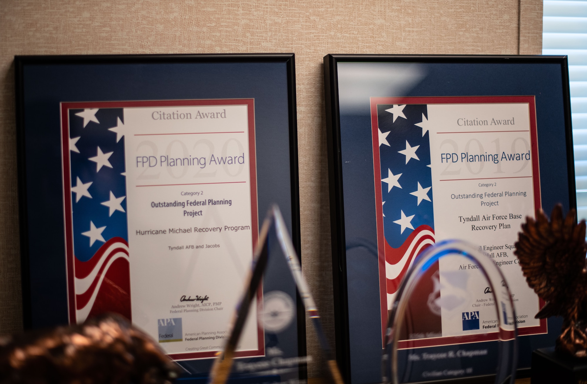 Two award plaques sit on the background, showing consecutive annual winnings