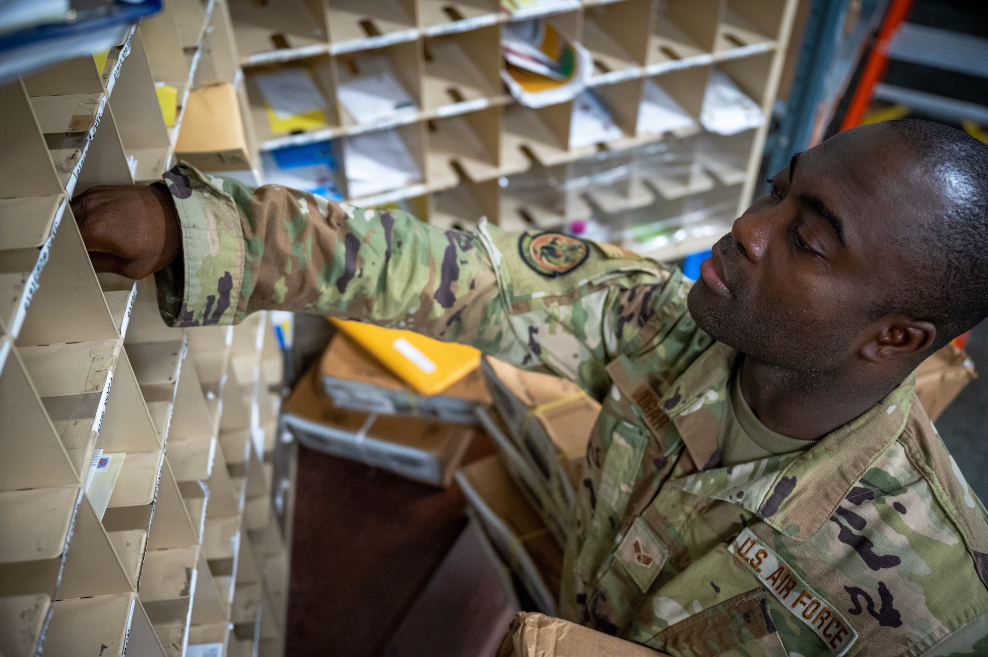 Senior Airman Ajay Vogar, 379th Expeditionary Maintenance Squadron commander support staff security manager, picks up mail from the post office, at Al Udeid Air Base, Qatar, July 27, 2021.