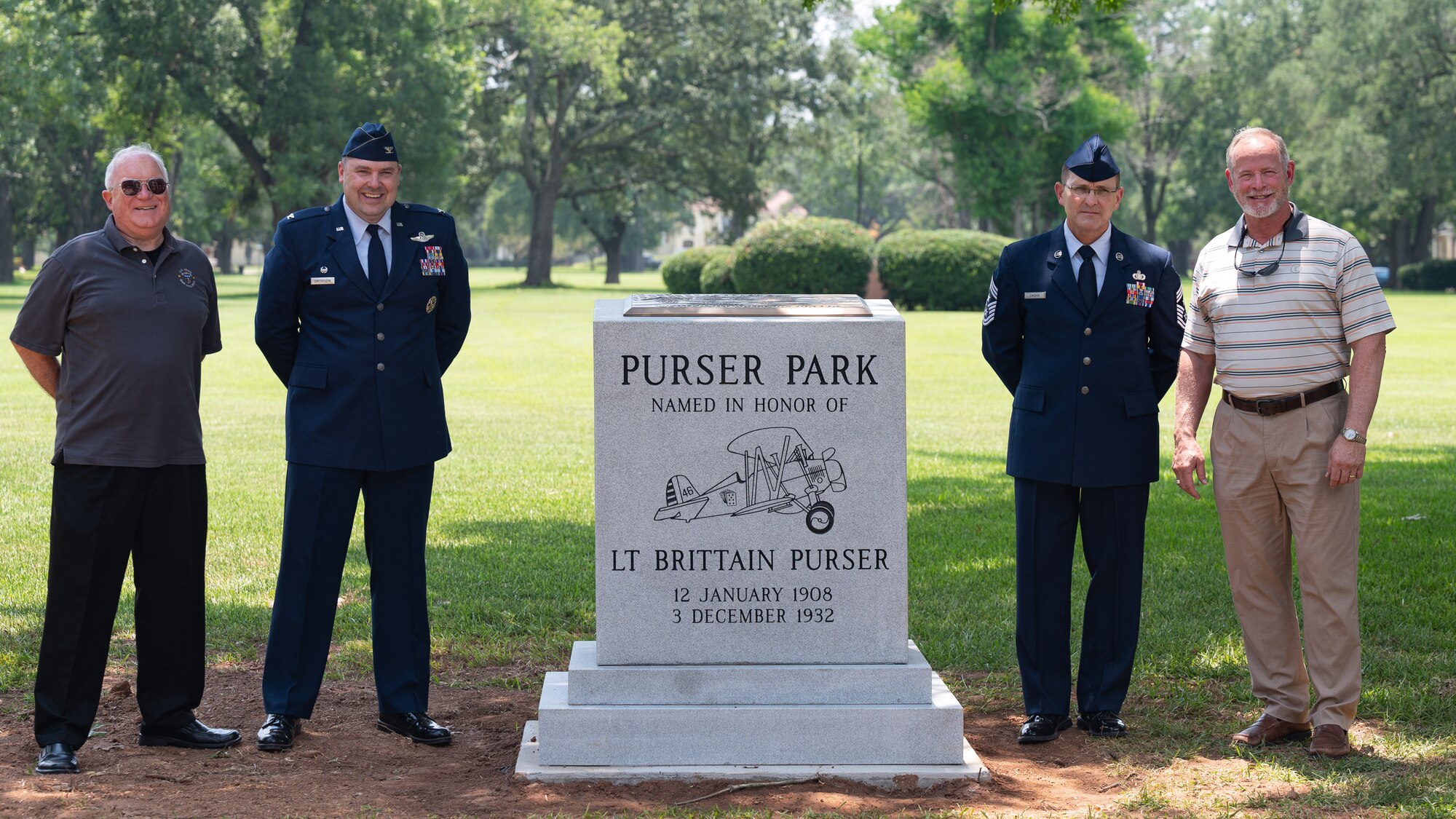 Col. Mark Dmytryszyn, left, 2nd Bomb Wing commander, and Chief Master Sgt. Travis Chadick, right, 2nd Bomb Wing command chief, pose for a photo with descendents of Lt. Brittain Purser during the Purser Park Monument unveiling ceremony at Barksdale Air Force Base, Louisiana, July 30, 2021. Lt. Brittain Purser was a pilot who passed away during a take-off collision at Barksdale and the monument honors his bravery and dedication to the Air Force mission. (U.S. Air Force photo by Airman 1st Class Jonathan E. Ramos)
