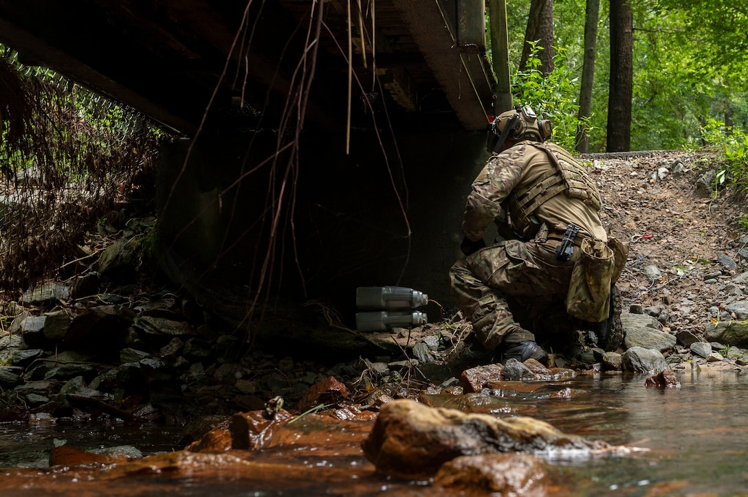 Staff Sgt. Damian Riley, 4th Civil Engineer Squadron explosive ordnance disposal technician, hooks up a remote cut and pull on a simulated improvised explosive device during field training exercise Operation Guillotine at Seymour Johnson Air Force Base, North Carolina, July 26, 2021.