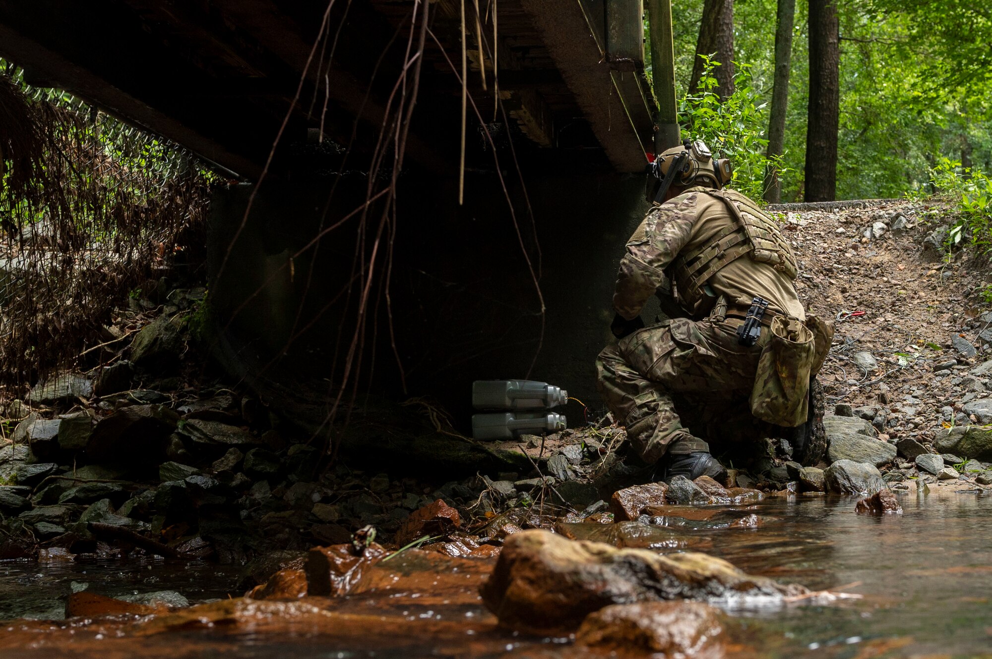 Staff Sgt. Damian Riley, 4th Civil Engineer Squadron explosive ordnance disposal technician, hooks up a remote cut and pull on a simulated improvised explosive device during field training exercise Operation Guillotine at Seymour Johnson Air Force Base, North Carolina, July 26, 2021.