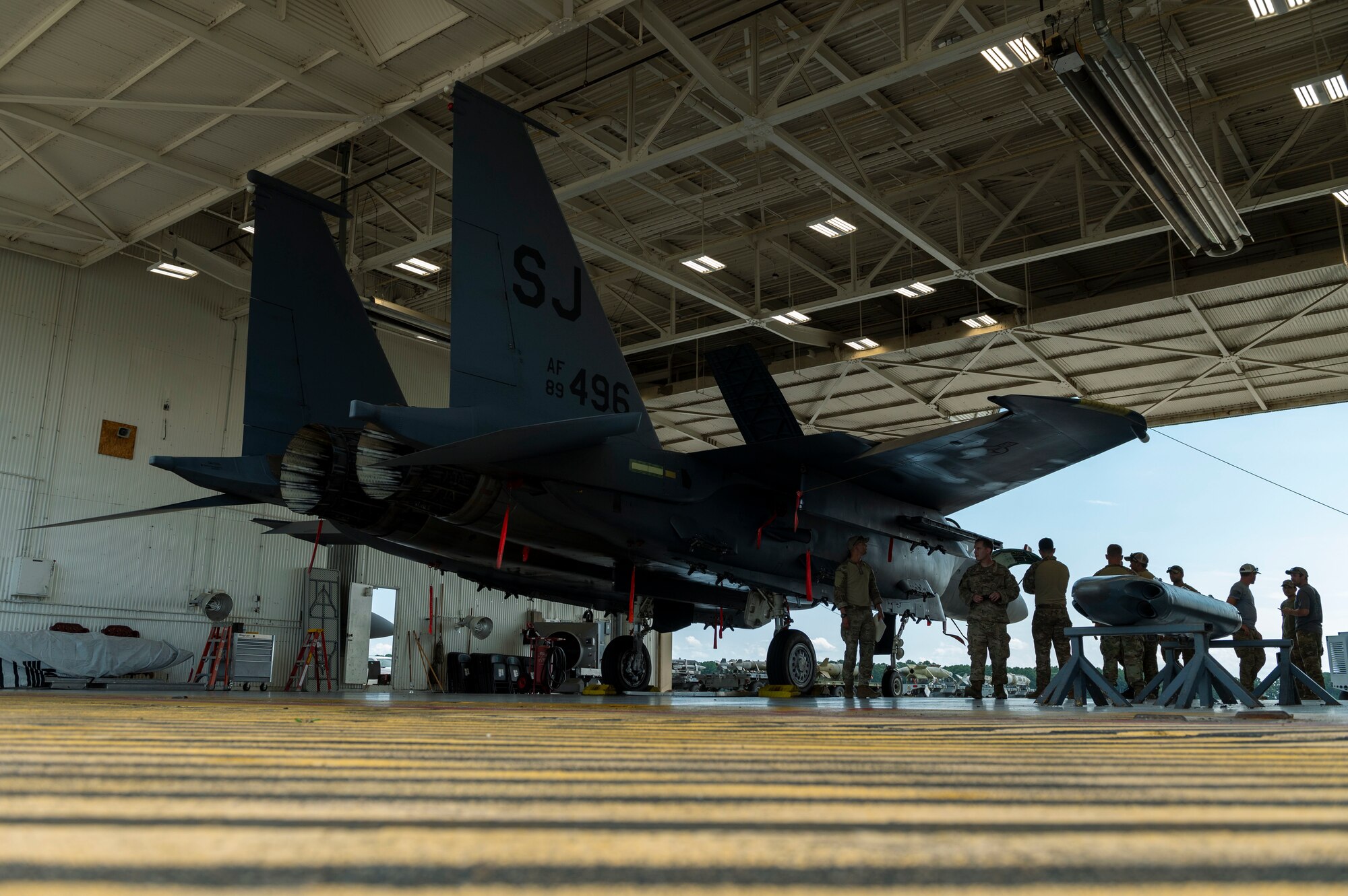 Explosive Ordnance Disposal technicians from Seymour Johnson Air Force Base, North Carolina, Shaw AFB, South Carolina and Andrews AFB, Maryland get familiarized with an F-15E Strike Eagle during field training exercise Operation Guillotine at Seymour Johnson Air Force Base, North Carolina, July 26, 2021.