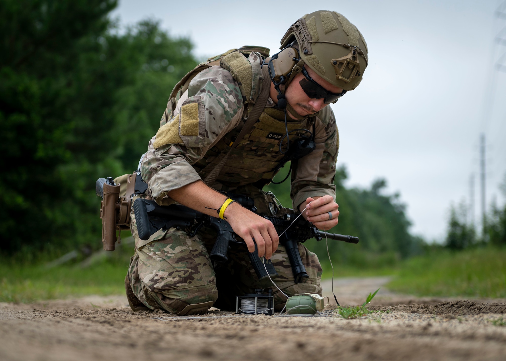 Airman 1st Class Braiden Bray, 4th Civil Engineer Squadron explosive ordnance disposal technician sets up a remote move on a dud-fired hand grenade during field training exercise Operation Guillotine at Seymour Johnson Air Force Base, North Carolina, July 27, 2021.
