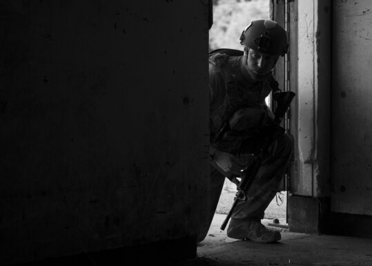 Staff Sgt. Hunter Eckwall, 20th Civil Engineer Squadron explosive ordnance disposal technician, enters a booby-trapped building during field training exercise Operation Guillotine at Seymour Johnson Air Force Base, North Carolina, July 27, 2021.