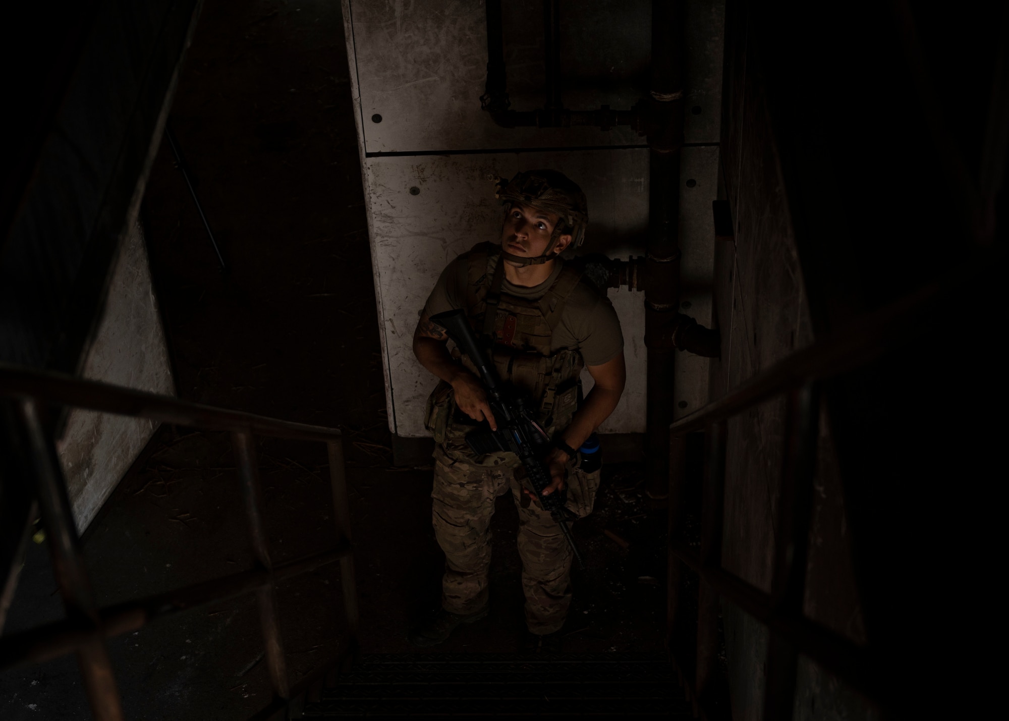 Airman 1st Class Jacobo Vasquez Cuartas, 20th Civil Engineer Squadron explosive ordnance disposal technician, looks upstairs before proceeding during field training exercise Operation Guillotine at Seymour Johnson Air Force Base, North Carolina, July 27, 2021.