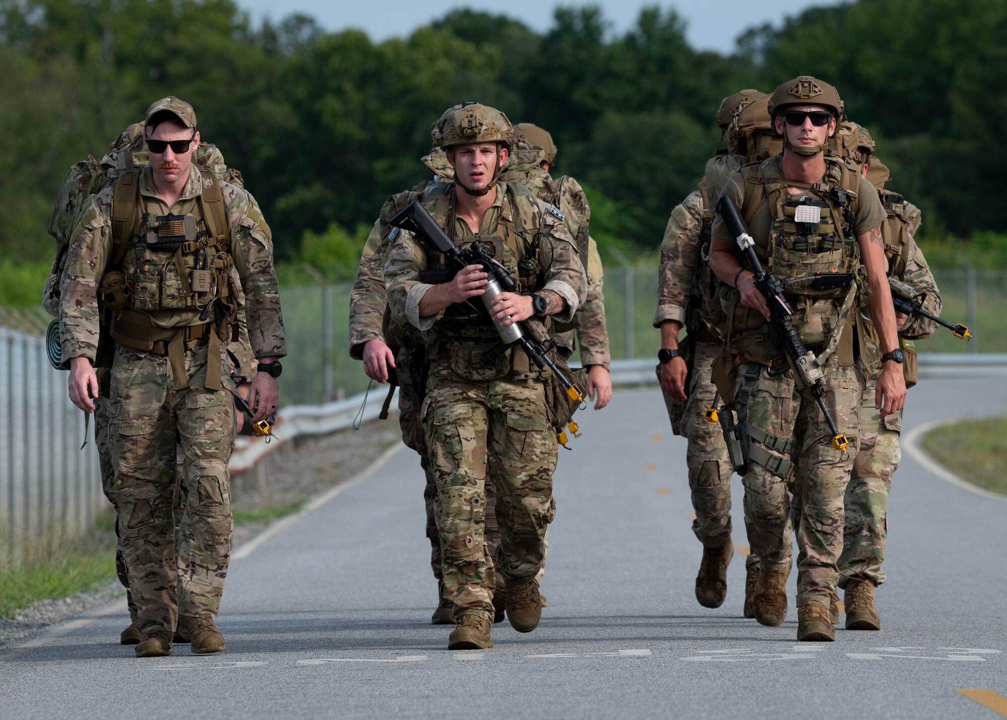 Explosive ordnance disposal members from Seymour Johnson Air Force Base, North Carolina, Andrews AFB, Maryland and Shaw AFB, South Carolina, ruck march to a training site on Seymour Johnson AFB, July 25, 2021. The EOD members participated in a five-day field training exercise, Operation Guillotine. (U.S. Air Force photo by Senior Airman Kimberly Barrera)