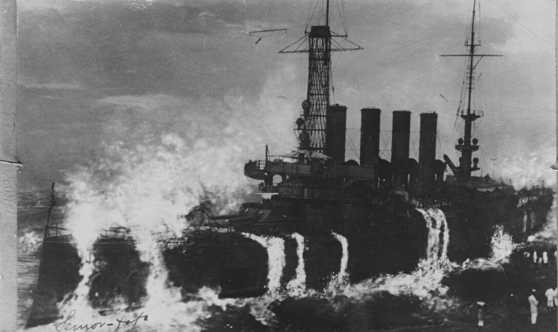 A large ship is pummeled by waves.