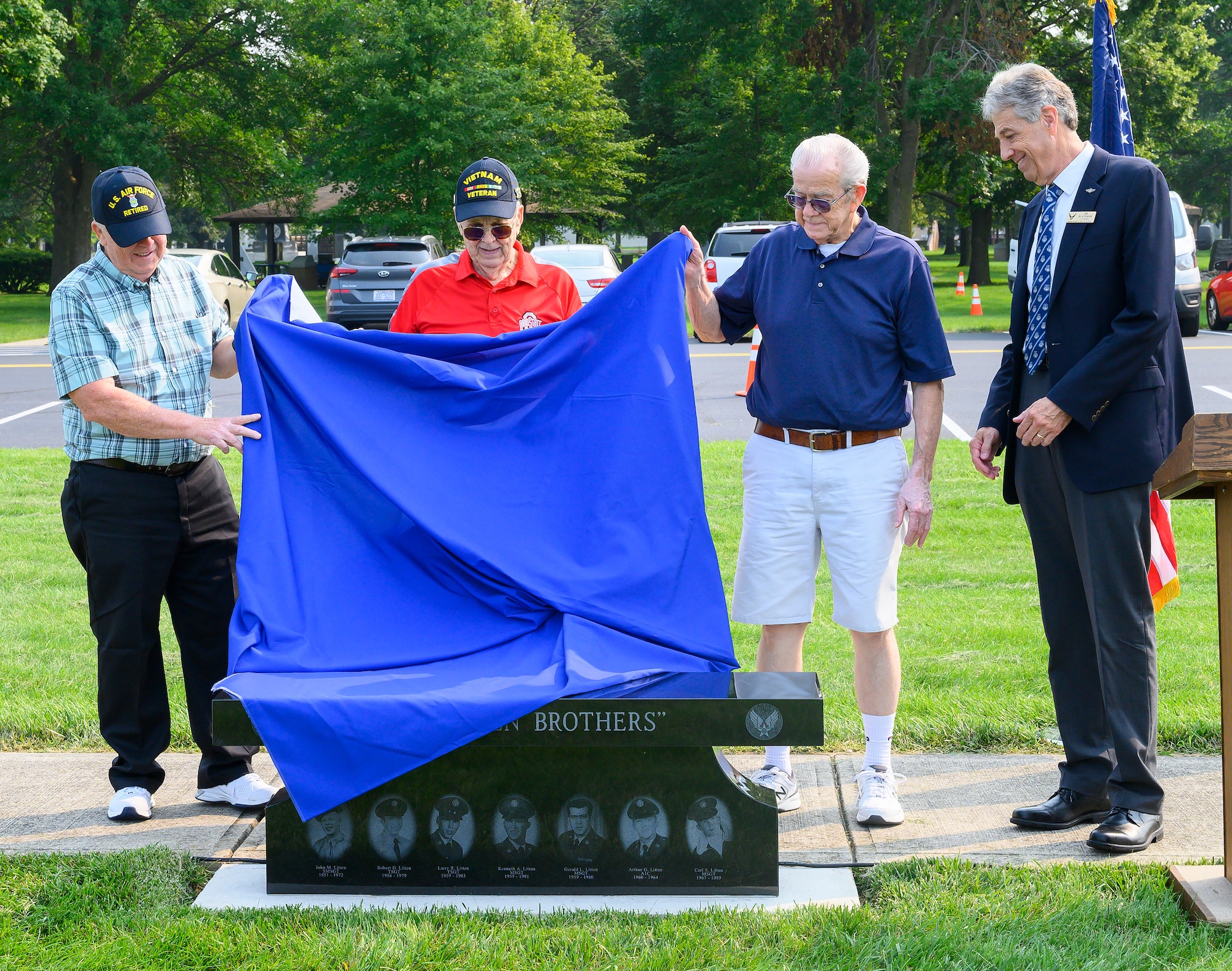 Steve (left), Larry (center) and Jerry Litten unveil a memorial bench honoring their brothers and them during a ceremony July 20, 2021, at the National Museum of the Air Force, Wright-Patterson Air Force Base, Ohio. The three, along with four other brothers, served a combined total of 137 years in the U.S. Air Force. (U.S. Air Force photo by R.J. Oriez)