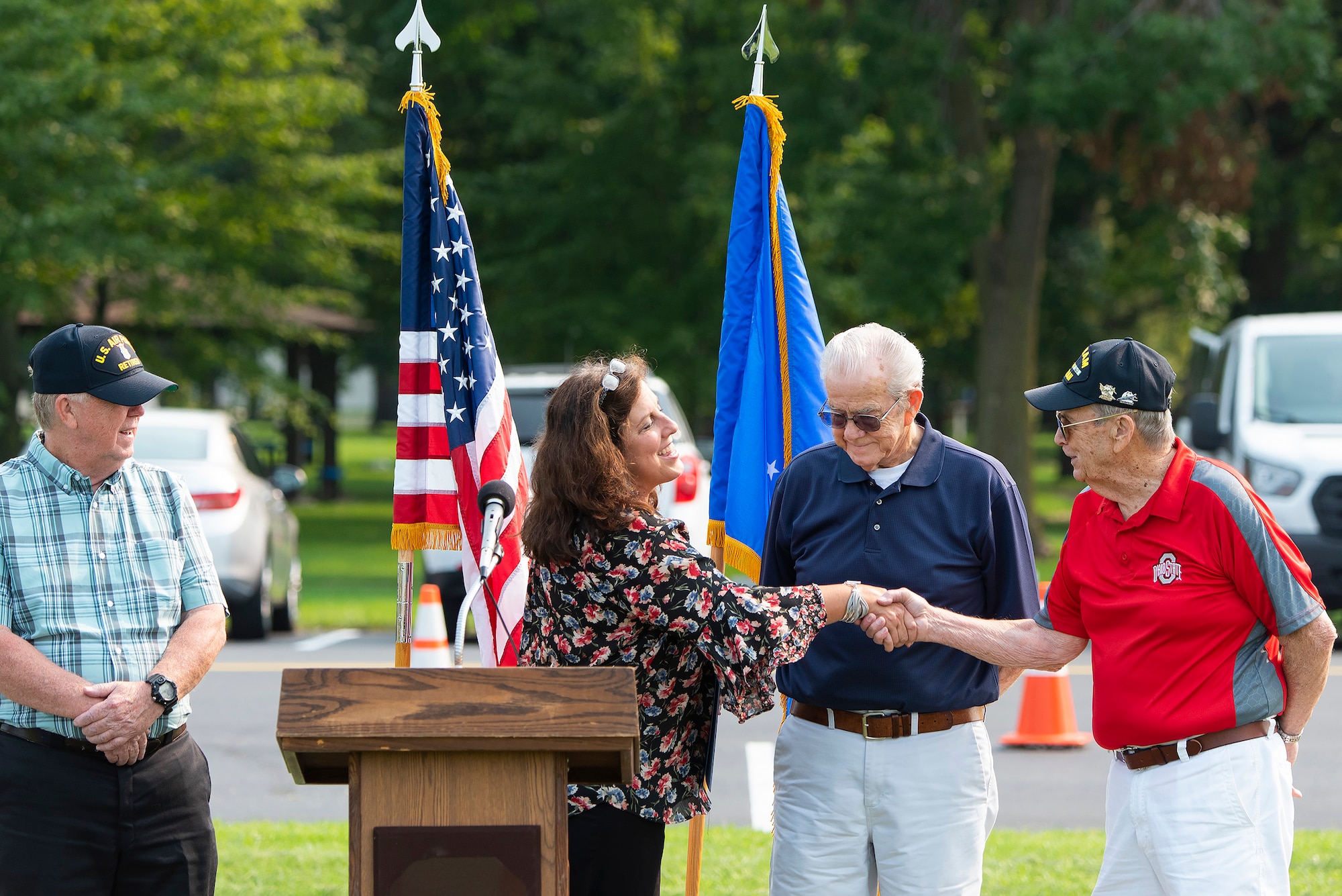 Sandra Brasington, Gov. Mike DeWine’s western Ohio regional liaison, thanks the surviving Litten brothers—Steve (left), Jerry (center) and Larry— for their service in the Air Force during a ceremony July 20, 2021, at the National Museum of the Air Force, Wright-Patterson Air Force Base, Ohio. They, and an additional four brothers, served a combined total of 137 years in the U.S. Air Force. (U.S. Air Force photo by R.J. Oriez)