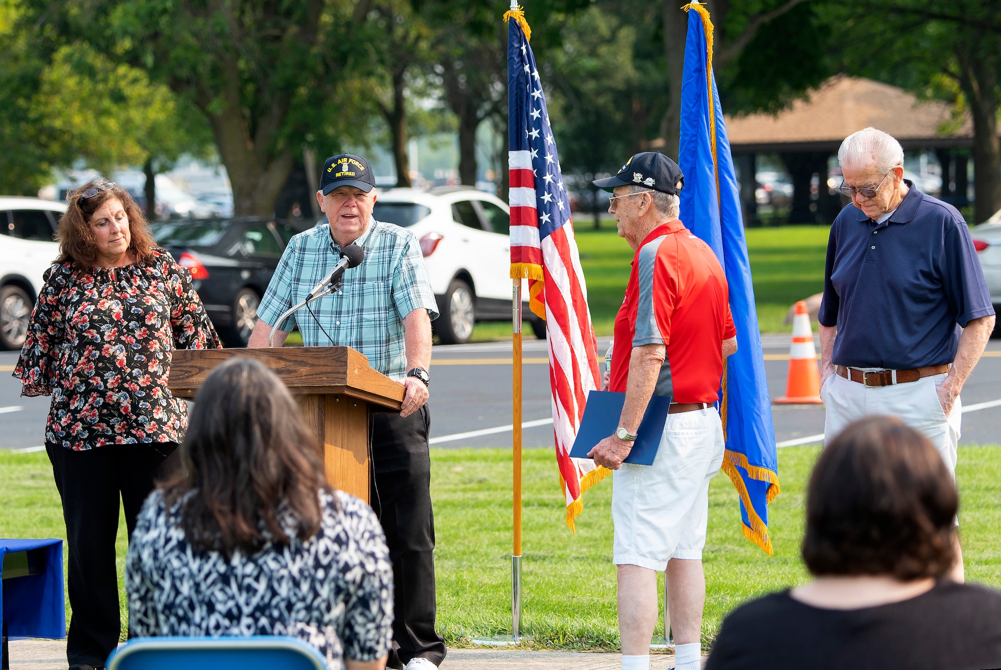 Steve Litten speaks as two of his brothers listen during a ceremony dedicating a memorial bench in their honor, at the National Museum of the Air Force, Wright-Patterson Air Force Base, Ohio, July 20, 2021. The seven Litten brothers honored on this bench served a combined total of 137 years in the U.S. Air Force. (U.S. Air Force photo by R.J. Oriez)