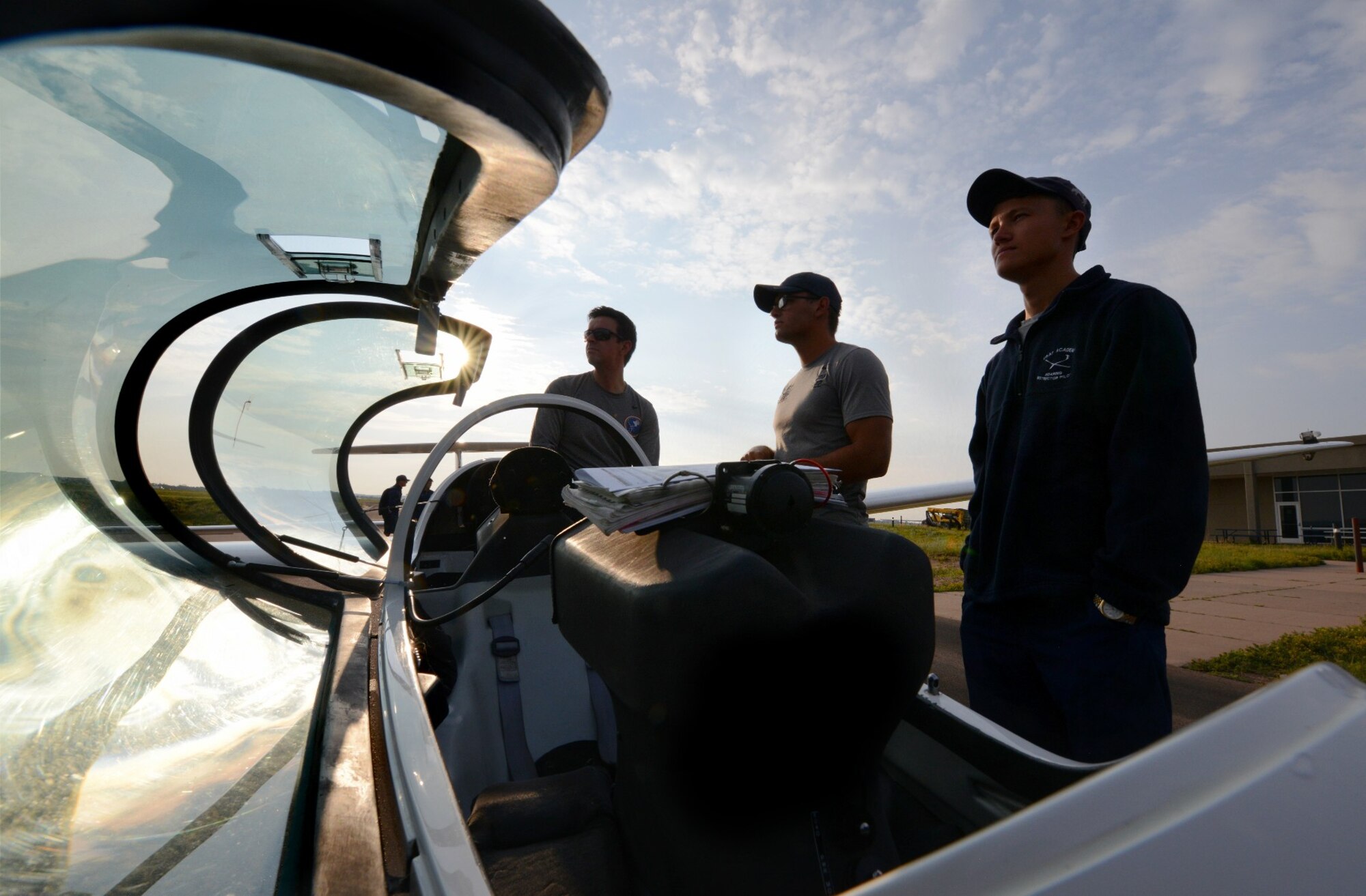 Maj. Chris Heiserman, the 94th Flying Training Squadron’s director of staff, and Air Force Academy Cadets 1st Class Garrett Dean and Sean Bedwell, conduct final flight checks on a glider.