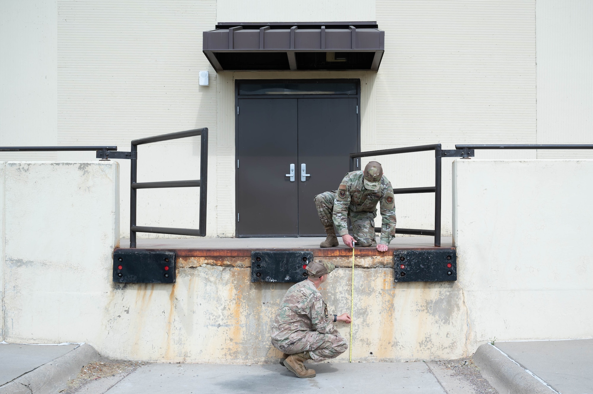 Staff Sgt. Justin Manning, right, 341st Missile Wing occupational safety technician, and Tech. Sgt. Mark Allen, left, 341st MW occupational safety NCO in charge, measure the height of a loading dock Aug. 2, 2021, at Malmstrom Air Force Base, Mont.